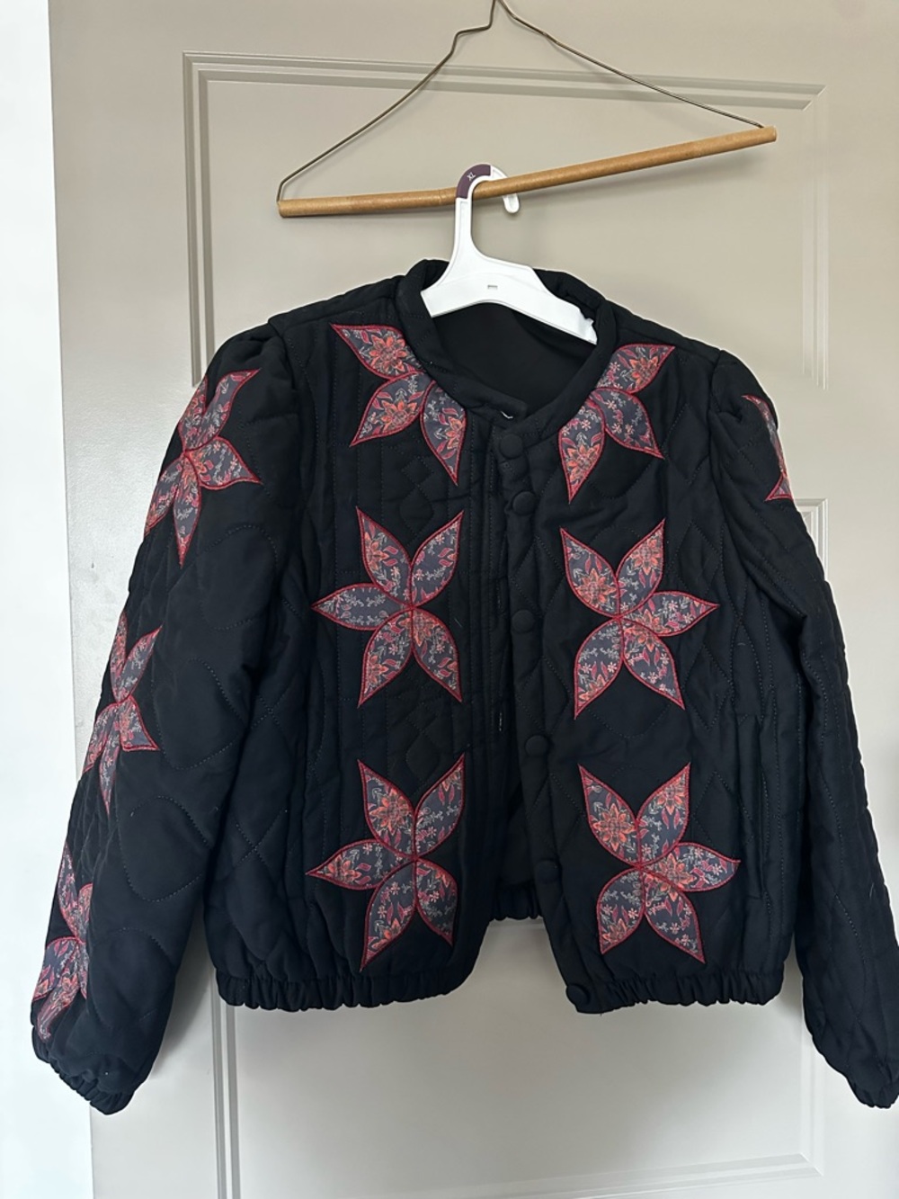 Black Quilted Jacket with Red Floral Star Appliqués